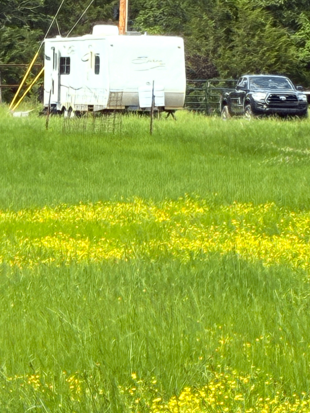 RV and truck parked in the field